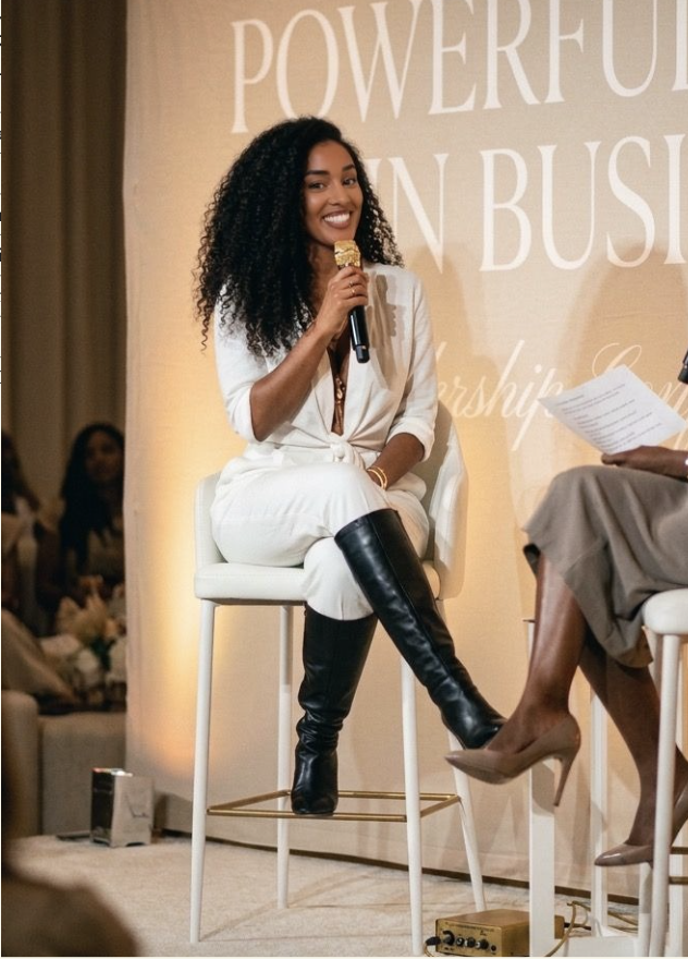 Alexa Rainville speaking on stage at a Powerful Women in Business panel